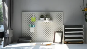 Home office wall storage ideas with a pegboard, shelves and hanging baskets above a small desk
