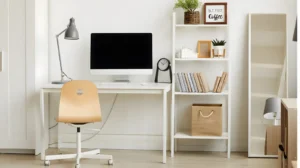 Aesthetic Home Office Ideas: The Complete 2026 Style Guide for a Beautiful, Productive Workspace 7 Minimalist Scandinavian home office with a light oak desk, white walls, a slim desk lamp, a pothos plant, and a muted grey ergonomic chair in a sunlit room