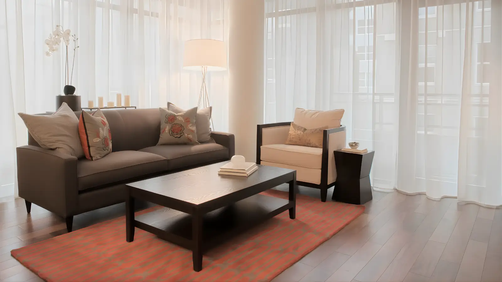 Studio Apartment Decor Ideas for Women-Bright feminine studio apartment with defined sleeping, living, and work zones using rugs, curtains, and warm lighting